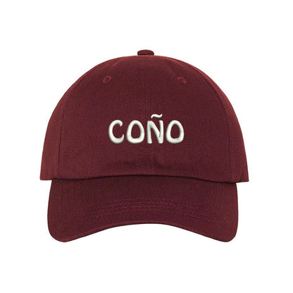 Burgundy baseball cap embroidered with Coño in the front and a Puerto Rico Flag on the back of the hat- DSY Lifestyle