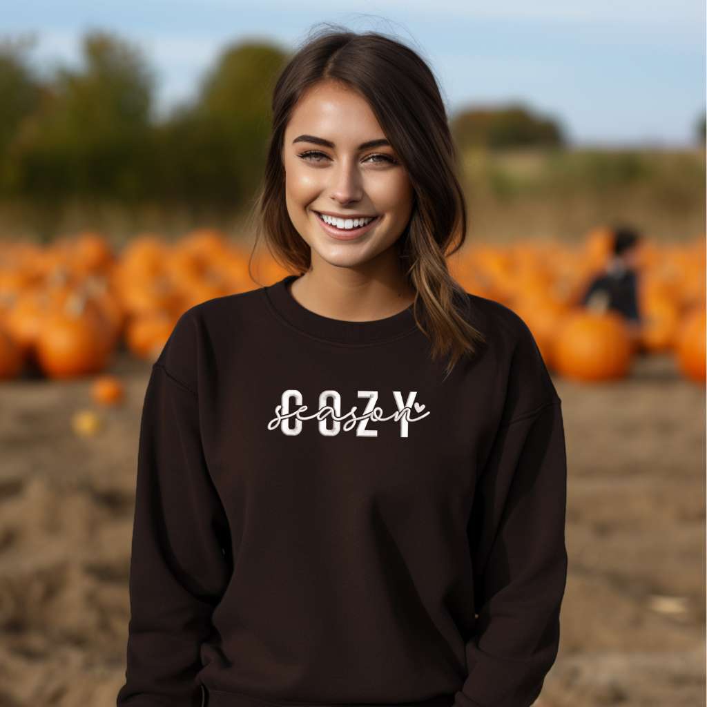 Female wearing a brown crewneck sweatshirt embroidered with Cozy Season - DSY Lifestyle