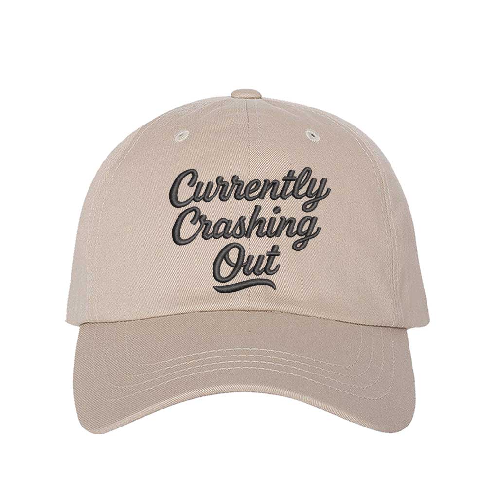 Stone with black thread Currently Crashing Out embroidered baseball hat. A statement baseball hat for women who love humor, comfort, and effortless everyday outfits. - DSY Lifestyle