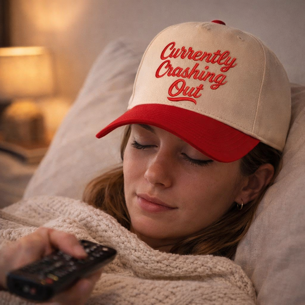 Female cozy wearing Natural Red Currently Crashing Out embroidered baseball hat. A two-tone statement hat for women who love humor, comfort, and effortless outfits. - DSY Lifestyle