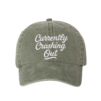 Olive Green Currently Crashing Out Embroidered Baseball Hat – a washed, relaxed-fit statement cap designed for everyday comfort and real-life moods. Trendy, adjustable, and effortlessly stylish. - DSY Lifestyle