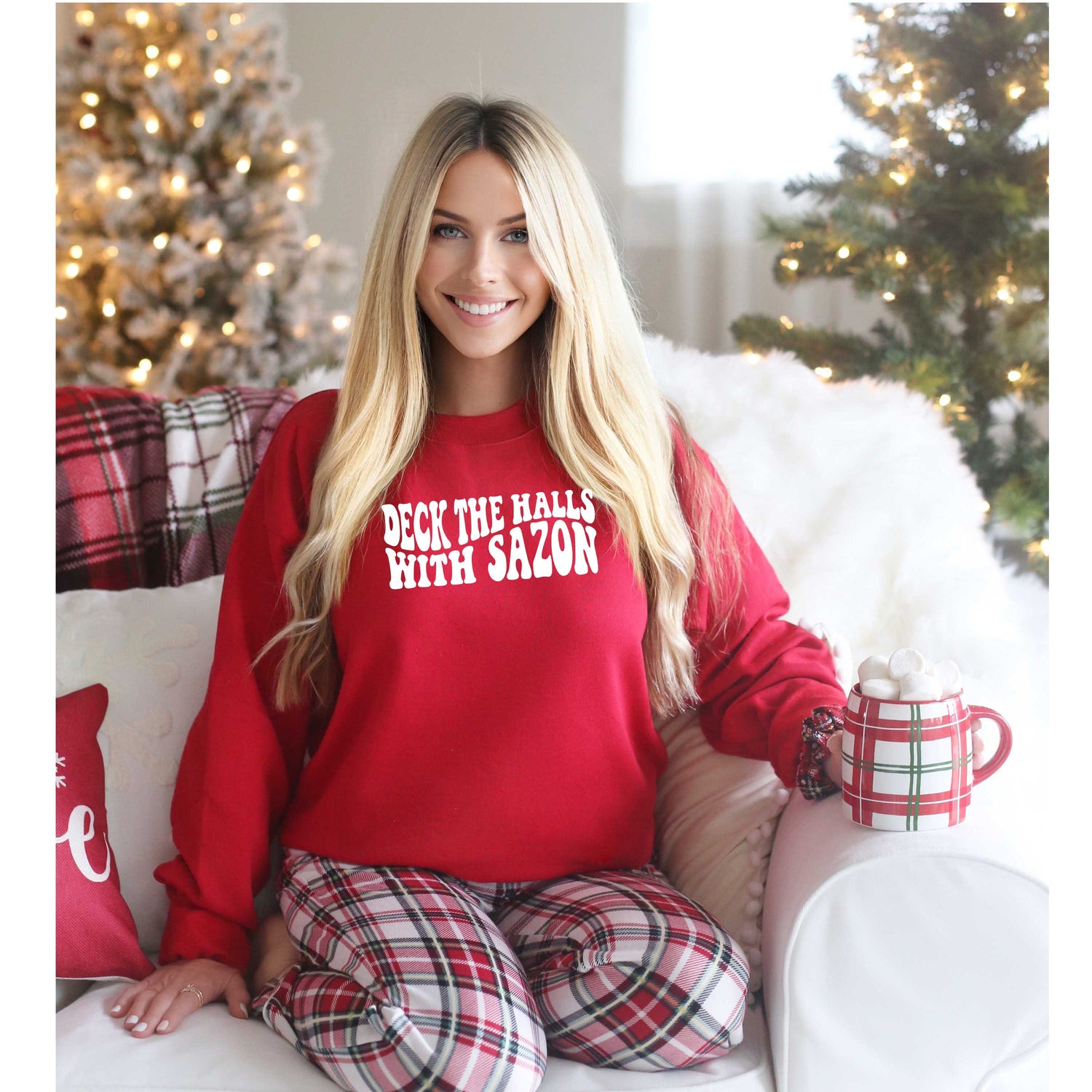 Model wearing Deck the Halls with Sazón red sweatshirt, a festive and cozy holiday sweater with Latin flair, perfect for gatherings and holiday celebrations.