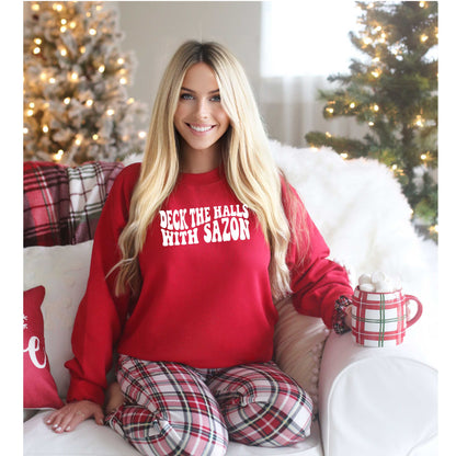 Model wearing Deck the Halls with Sazón red sweatshirt, a festive and cozy holiday sweater with Latin flair, perfect for gatherings and holiday celebrations.