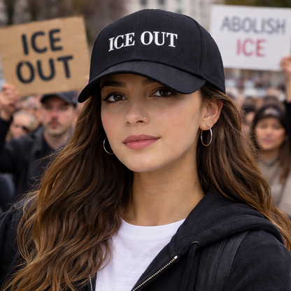 Determined female protestor wearing a Black Ice Out Old English Baseball Hat featuring white Gothic embroidery on a classic cap; inspired by Bad Bunny&