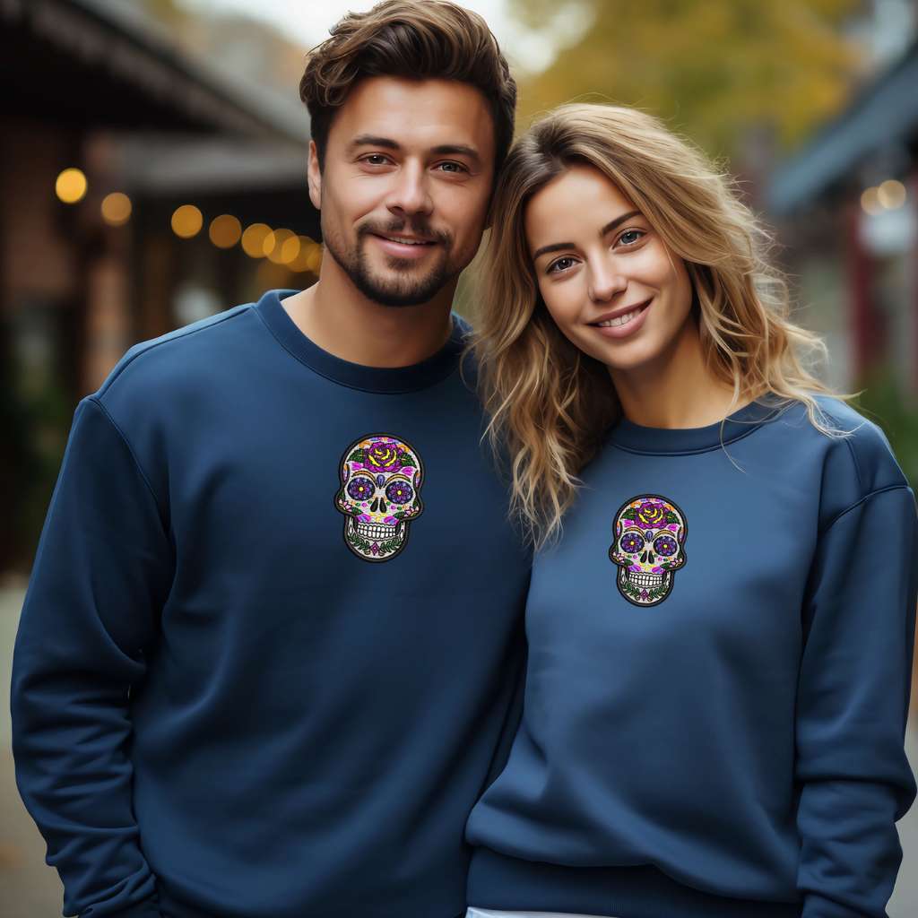 A couple wearing navy blue sweatshirts embroidered with a Dia de los Muertos sugar skull - DSY Lifestyle