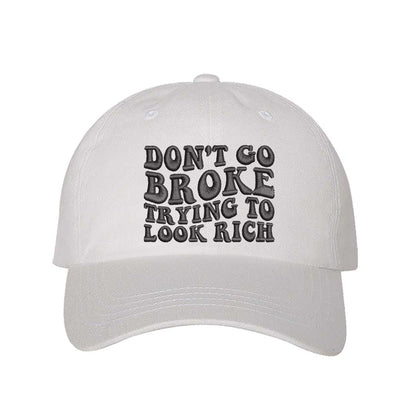 White Don’t Go Broke Trying to Look Rich Embroidered Baseball Hat in soft cotton with curved brim and hook and loop closure. DSY Lifestyle.