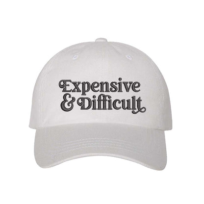 White baseball hat embroidered with the phrase  expensive and difficult-DSY Lifestyle