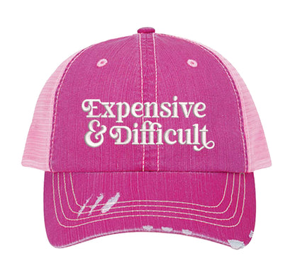 Pink DSY Lifestyle distressed trucker hat featuring the phrase Expensive &amp; Difficult in bold, professional embroidery. - DSY Lifestyle