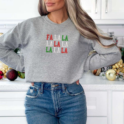 Female wearing a heather gray sweatshirt embroidered with Fa la la in Christmas Colors - DSY Lifestyle