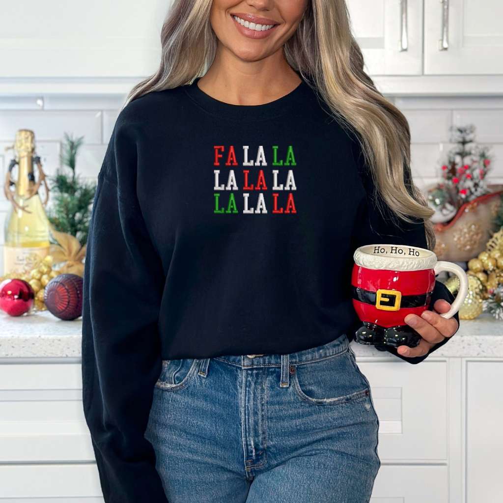 Female wearing a navy sweatshirt embroidered with Fa la la in Christmas Colors - DSY Lifestyle