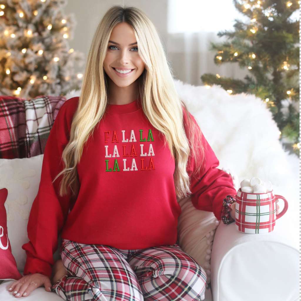 Female wearing a red sweatshirt embroidered with Fa la la in Christmas Colors - DSY Lifestyle