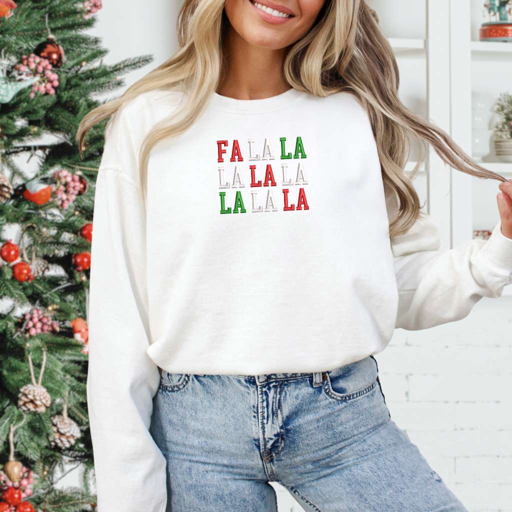 Female wearing a white sweatshirt embroidered with Fa la la in Christmas Colors - DSY Lifestyle