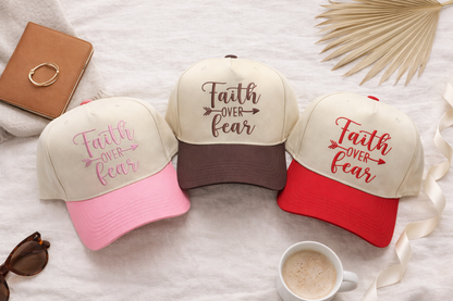 Flat lay of a DSY Lifestyle two-tone baseball hats with a neutral crown and contrast bill, featuring the words Faith Over Fear in bold, detailed embroidery. - DSY Lifestyle