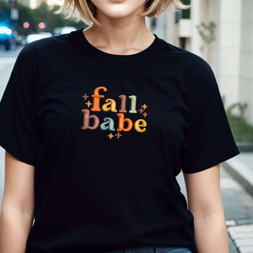 Female wearing a black t-shirt embroidered with Fall Babe - DSY Lifestyle