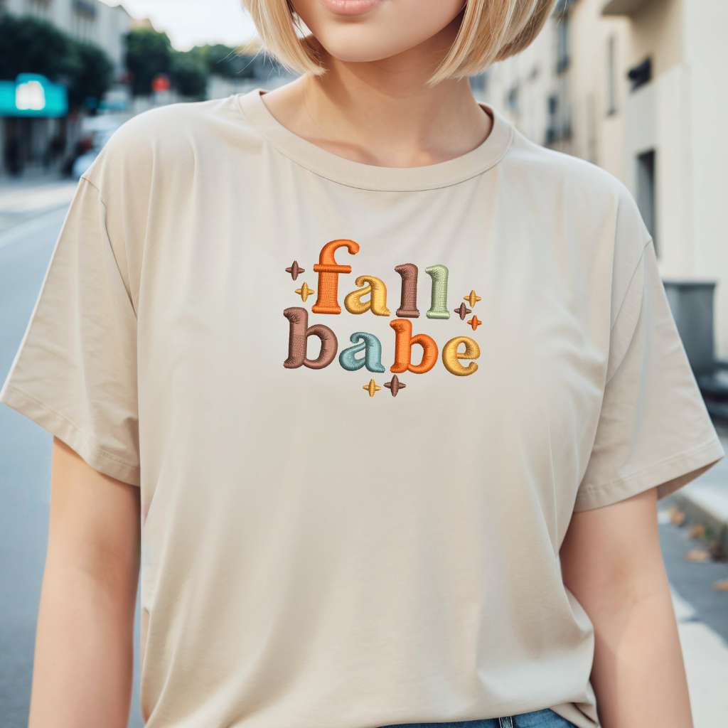 Female wearing a sand t-shirt embroidered with Fall Babe - DSY Lifestyle