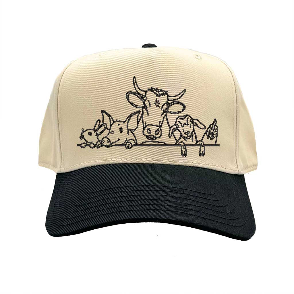 Natural Black DSY Lifestyle two-tone baseball hat with a natural crown and  contrasting bill, featuring an embroidered graphic of a cow, pig, and rooster family. - DSY Lifestyle