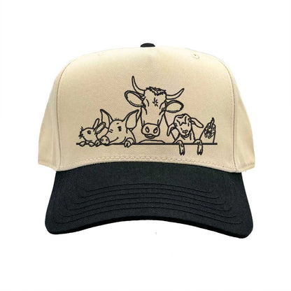 Natural Black DSY Lifestyle two-tone baseball hat with a natural crown and  contrasting bill, featuring an embroidered graphic of a cow, pig, and rooster family. - DSY Lifestyle