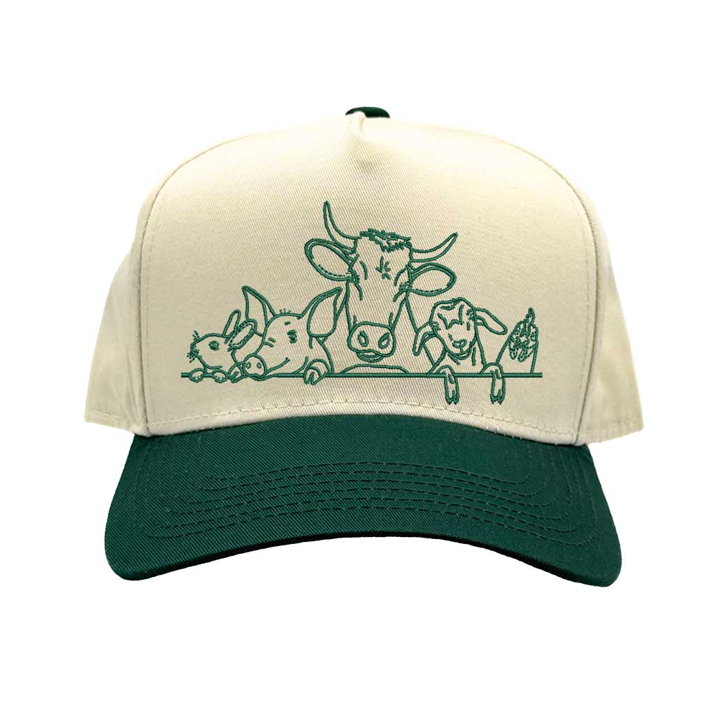 Natural Forest Green DSY Lifestyle two-tone baseball hat with a natural crown and  contrasting bill, featuring an embroidered graphic of a cow, pig, and rooster family. - DSY Lifestyle