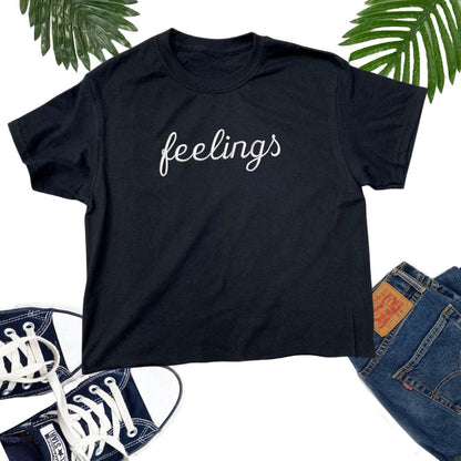 Flat lay of a black crop top embroidered with Feelings _ DSY Lifestyle