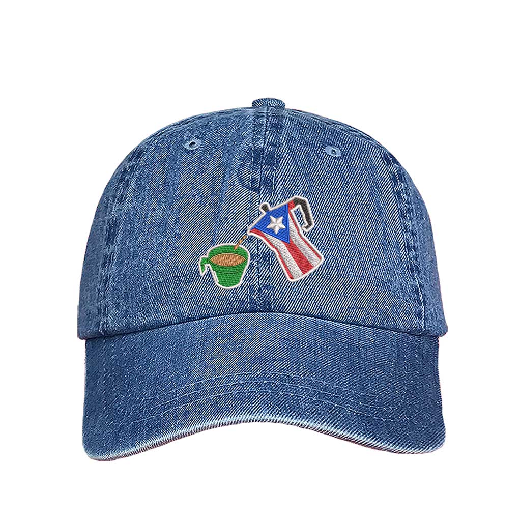 A light denim embroidered hat featuring a detailed design of a greca (stovetop coffee maker) pouring coffee into a nostalgic green butter cup, symbolizing Puerto Rican coffee culture. The greca has the Puerto Rican flag inside it, representing heritage and tradition - DSY Lifestyle.