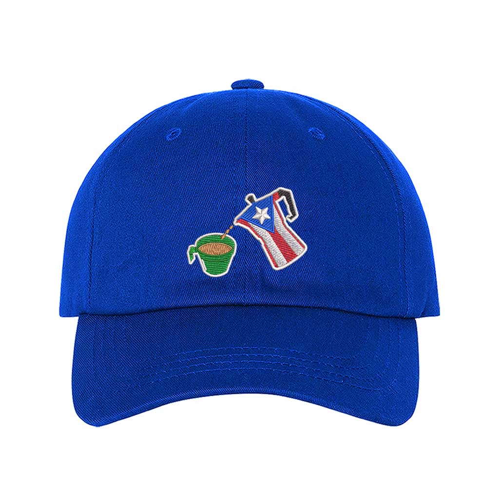 A royal blue embroidered hat featuring a detailed design of a greca (stovetop coffee maker) pouring coffee into a nostalgic green butter cup, symbolizing Puerto Rican coffee culture. The greca has the Puerto Rican flag inside it, representing heritage and tradition. -DSY Lifestyle