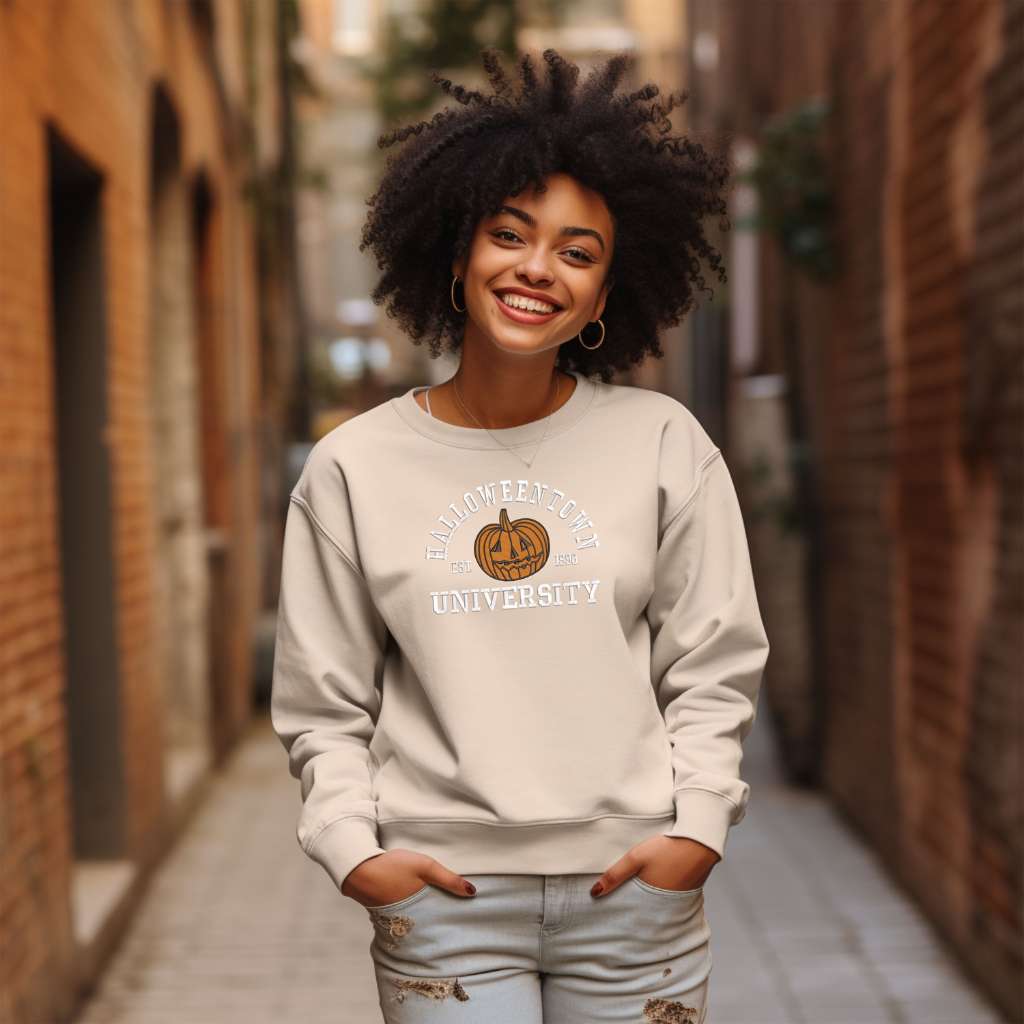 Female wearing a sand sweatshirt embroidered with Halloweentown University Est. 1998 and a pumpkin - DSY Lifestyle