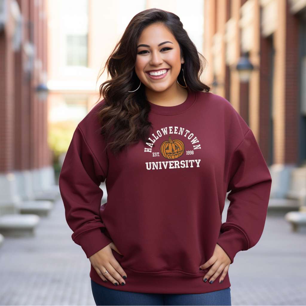 Female wearing a burgundy sweatshirt embroidered with Halloweentown University Est. 1998 and a pumpkin - DSY Lifestyle