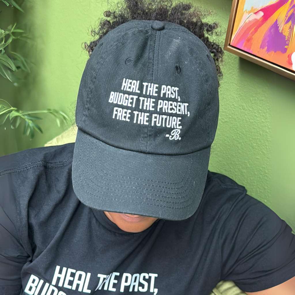Front view of the "Heal the Past, Budget the Present, Free the Future" hat – A close-up angle captures the embroidered text, highlighting the sleek and stylish design.