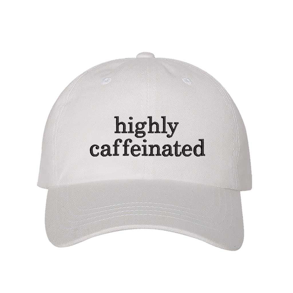 White cotton baseball hat featuring the phrase Highly Caffeinated in bold, crisp black embroidery. - DSY Lifestyle