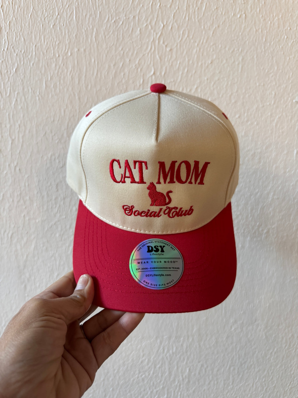 Cat Mom Social Club embroidered two-tone trucker hat on a white background