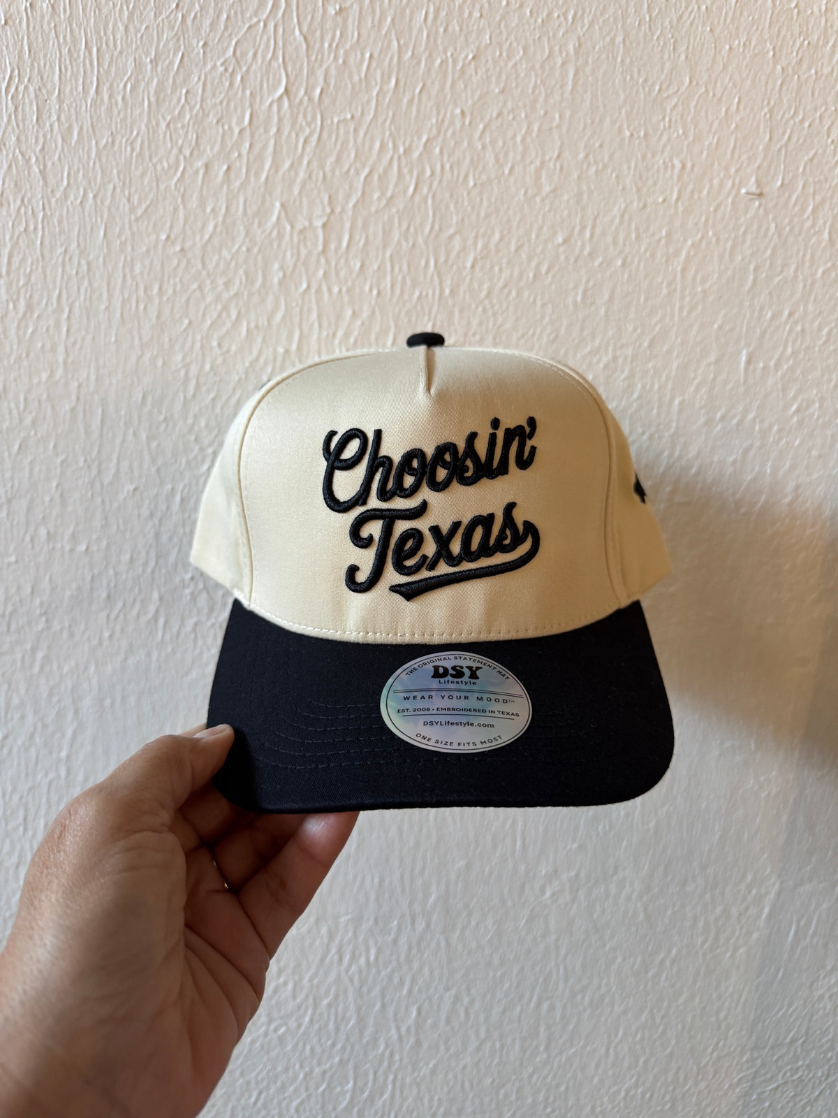 Choosin’ Texas embroidered two-tone trucker hat on a white background