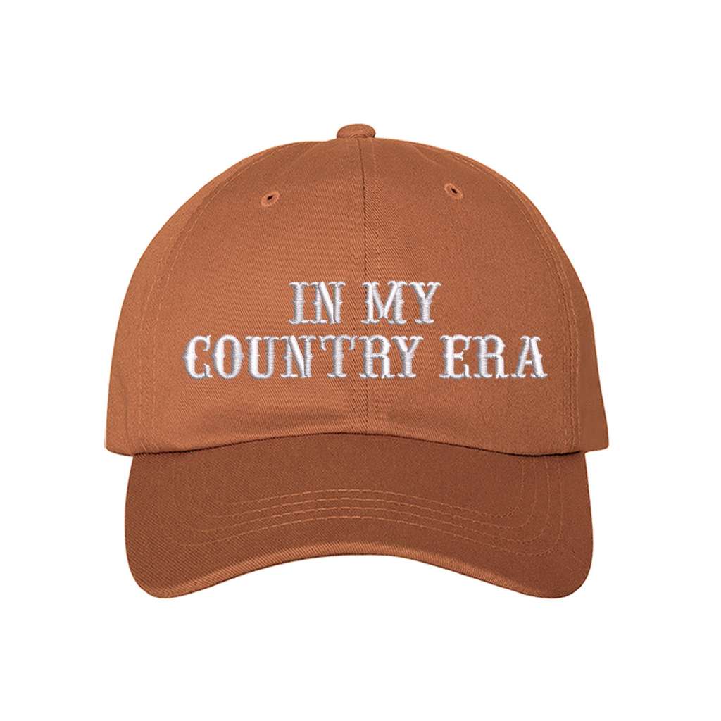 Burnt Orange Baseball hat thats embroidered with the phrase in my country era on the front-DSY Lifestyle 