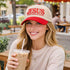 Female sipping iced coffee wearing a Natural Red Jesus The Way The Truth The Life 3D Two-Tone Hat featuring bold 3D raised embroidery on a natural crown with a contrasting visor; a premium faith statement by DSY Lifestyle.