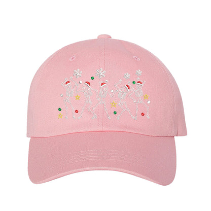 Light Pink Dancing Skeletons Christmas Embroidered Baseball Hat featuring festive dancing skeleton embroidery and adjustable hook and loop closure – DSY Lifestyle.
