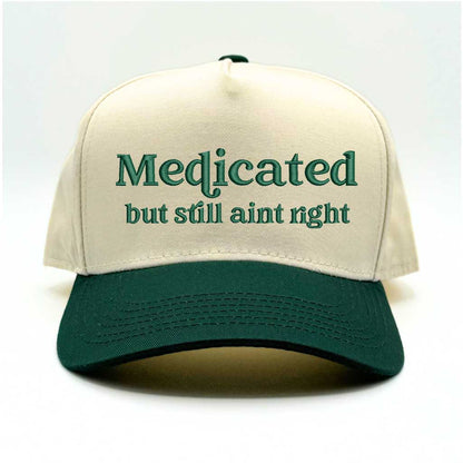 Natural with Forest Green bill Two-tone 5-panel baseball hat with &quot;Medicated But Still Ain’t Right&quot; embroidered in bold lettering, featuring a structured fit and adjustable strap for a comfortable, stylish look - DSY Lifestyle