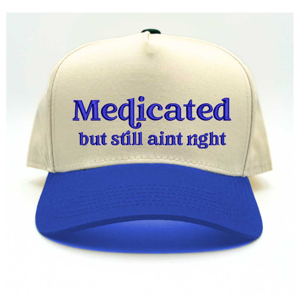 Natural with Royal Blue bill Two-tone 5-panel baseball hat with &quot;Medicated But Still Ain’t Right&quot; embroidered in bold lettering, featuring a structured fit and adjustable strap for a comfortable, stylish look - DSY Lifestyle