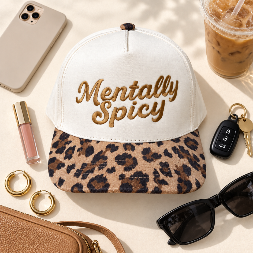 A white trucker-style cap with gold embroidered text reading &
