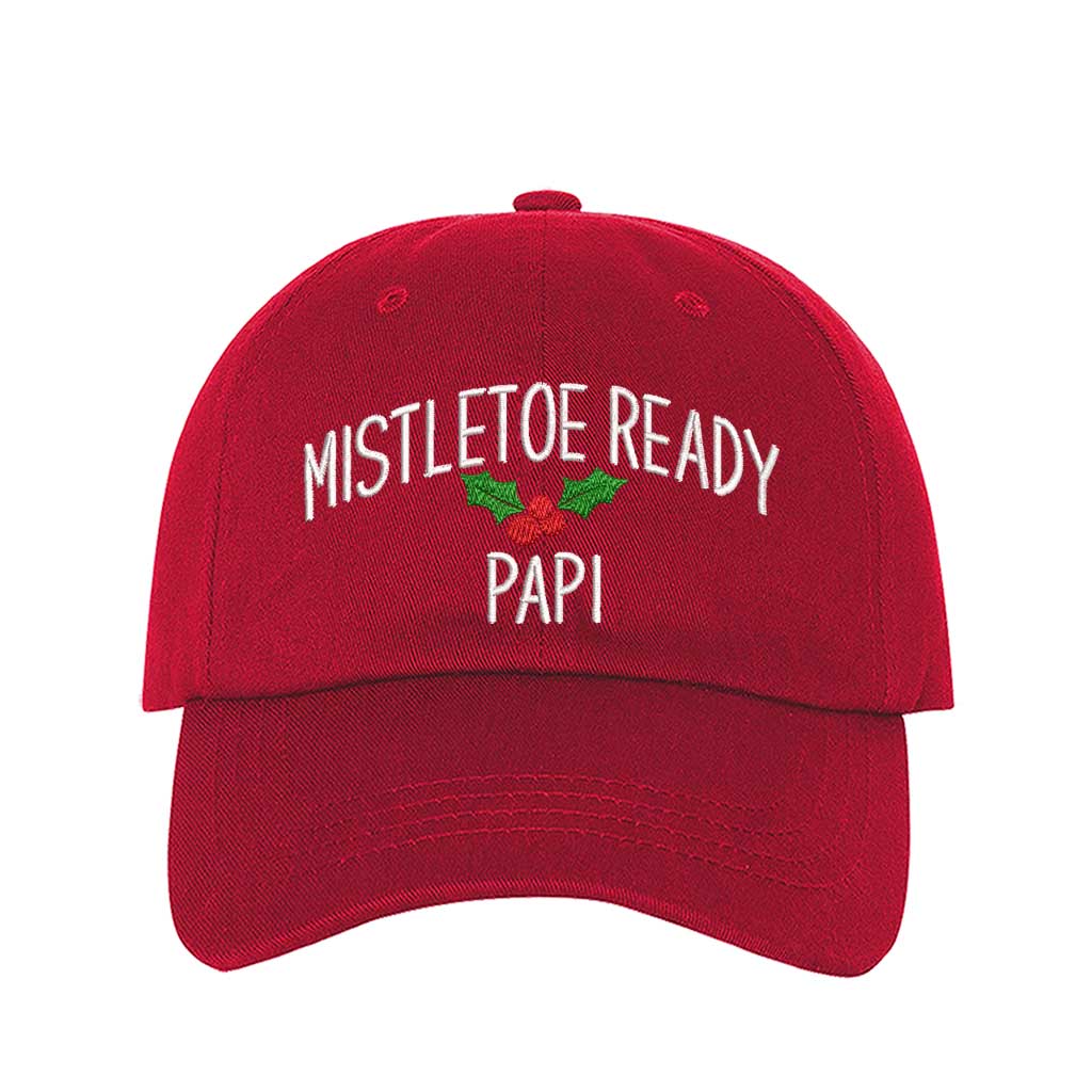 A festive Red baseball hat embroidered with Mistletoe Ready Papi and mistletoe, perfect for holiday parties and Spanglish Christmas vibes. DSY Lifestyle