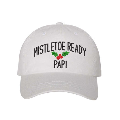 A festive White  baseball hat embroidered with Mistletoe Ready Papi and mistletoe, perfect for holiday parties and Spanglish Christmas vibes. DSY Lifestyle