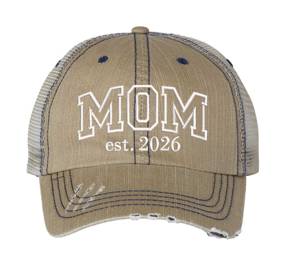 Khaki MOM Est. 2026 Distressed Trucker Hat. This premium vintage-style cap is the perfect gift for the unapologetically bold, featuring a breathable mesh back and custom embroidery. - DSY Lifestyle