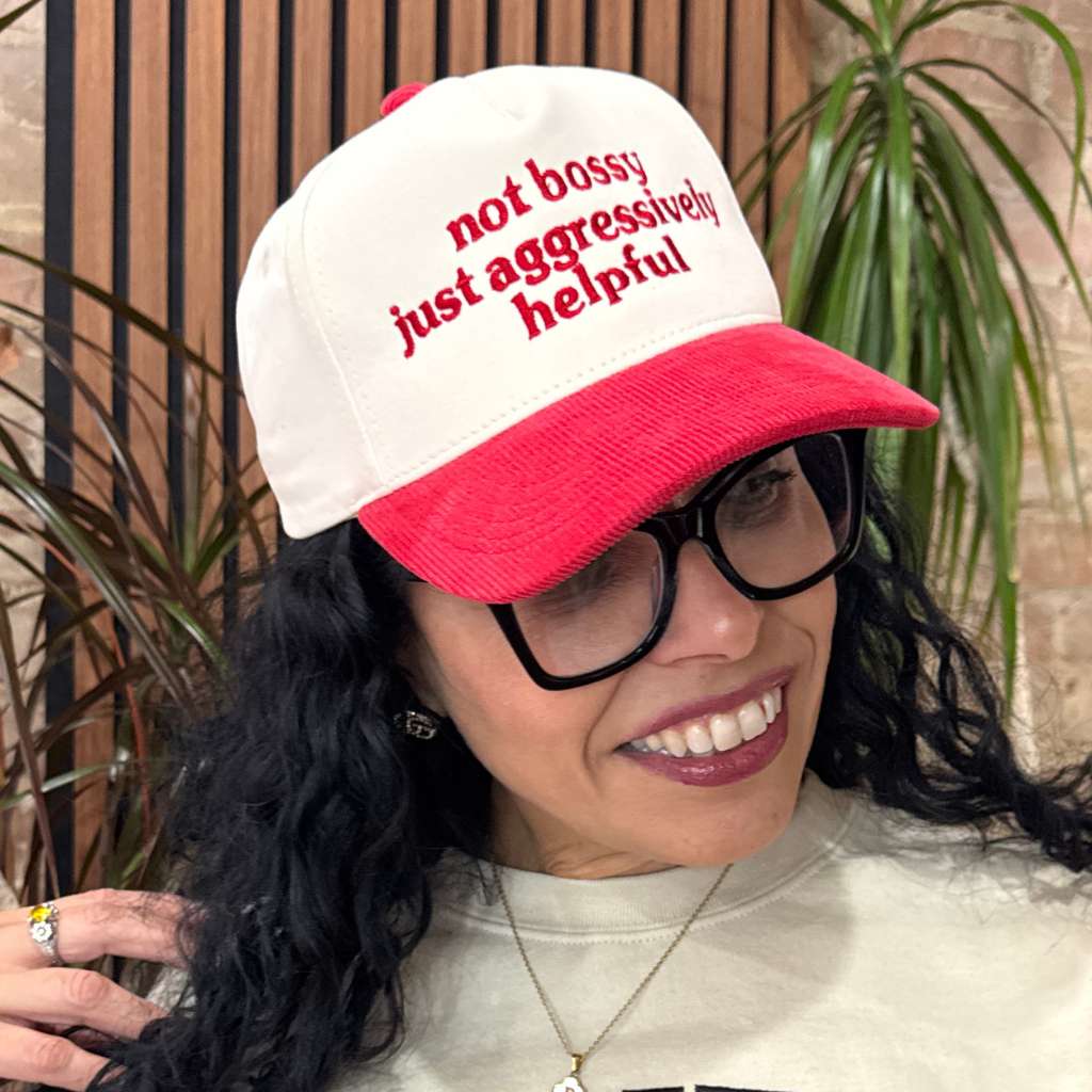 Latina woman wearing Not Bossy Just Aggressively Helpful embroidered corduroy baseball cap. Trendy statement hat for casual streetwear and empowered style – DSY Lifestyle.