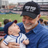 Handsome grandpa holding grandson wearing a Black Pop Pop Est. 2026 Baseball Hat featuring bold white embroidery on a premium dad cap; a stylish 2026 announcement gift for new grandfathers by DSY Lifestyle.
