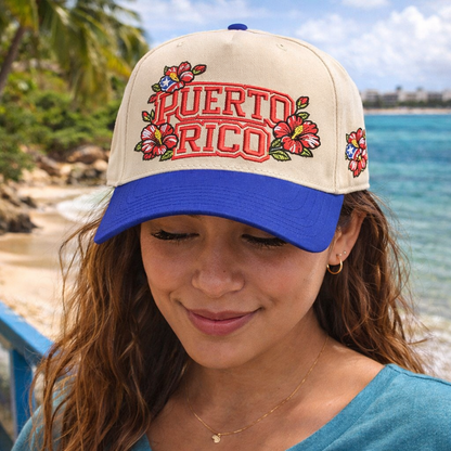 Female on the beach wearing a Natural Royal Blue Puerto Rico in Bloom embroidered baseball hat. A two-tone statement hat for women who love culture, effortless outfits, and bold style. - DSY Lifestyle