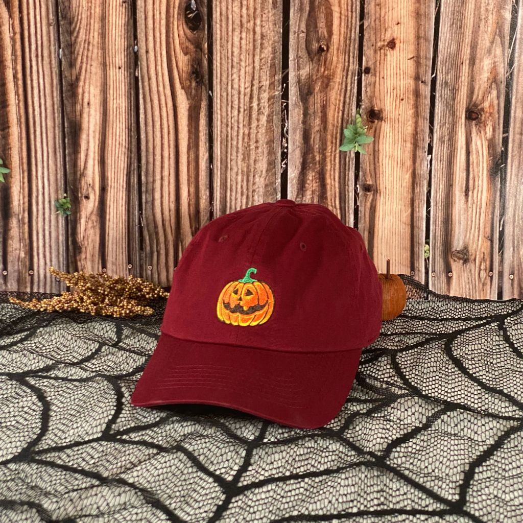 Burgundy Baseball hat embroidered with a orange jack o&