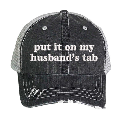 Black front profile view of a DSY Lifestyle distressed trucker hat featuring the words Put It On My Husband&