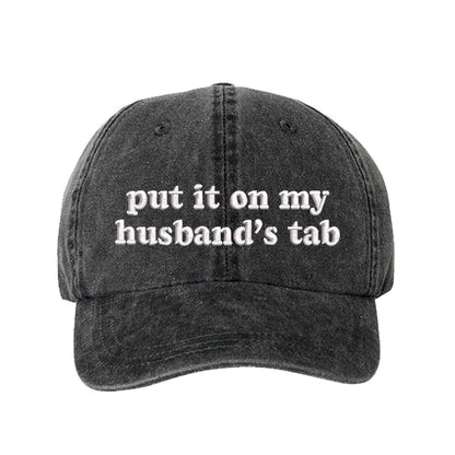 Black Put It On My Husband’s Tab washed cotton baseball hat with a soft finish and high-density white embroidery by DSY Lifestyle. - DSY Lifestyle