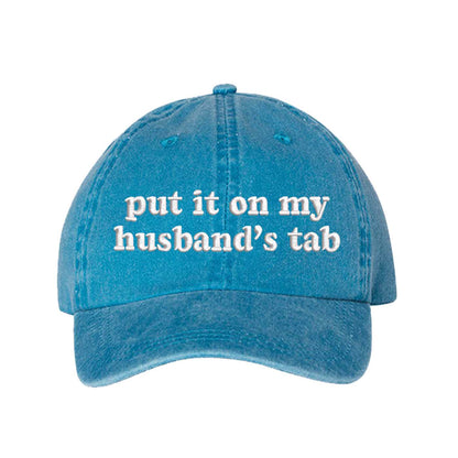 Turquoise Put It On My Husband’s Tab washed cotton baseball hat with a soft finish and high-density white embroidery by DSY Lifestyle. - DSY Lifestyle