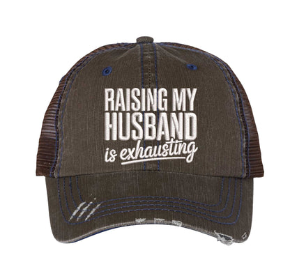 Brown DSY Lifestyle distressed trucker hat featuring the phrase Raising My Husband Is Exhausting in bold, professional embroidery. - DSY Lifestyle