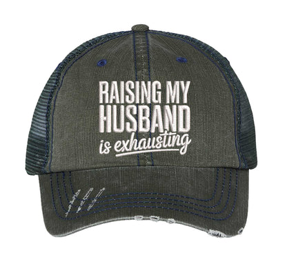 Dark Green DSY Lifestyle distressed trucker hat featuring the phrase Raising My Husband Is Exhausting in bold, professional embroidery. - DSY Lifestyle