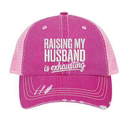 Pink DSY Lifestyle distressed trucker hat featuring the phrase Raising My Husband Is Exhausting in bold, professional embroidery. - DSY Lifestyle